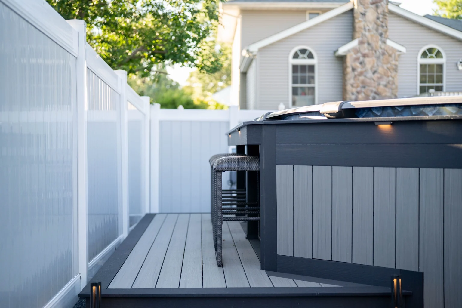 A close view of the lower deck platform and bar seating beside grey vertical skirting and dark trim.