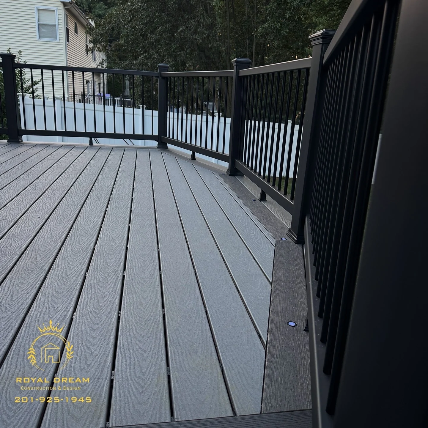 A closer view of the board texture, picture-frame border and black railing.