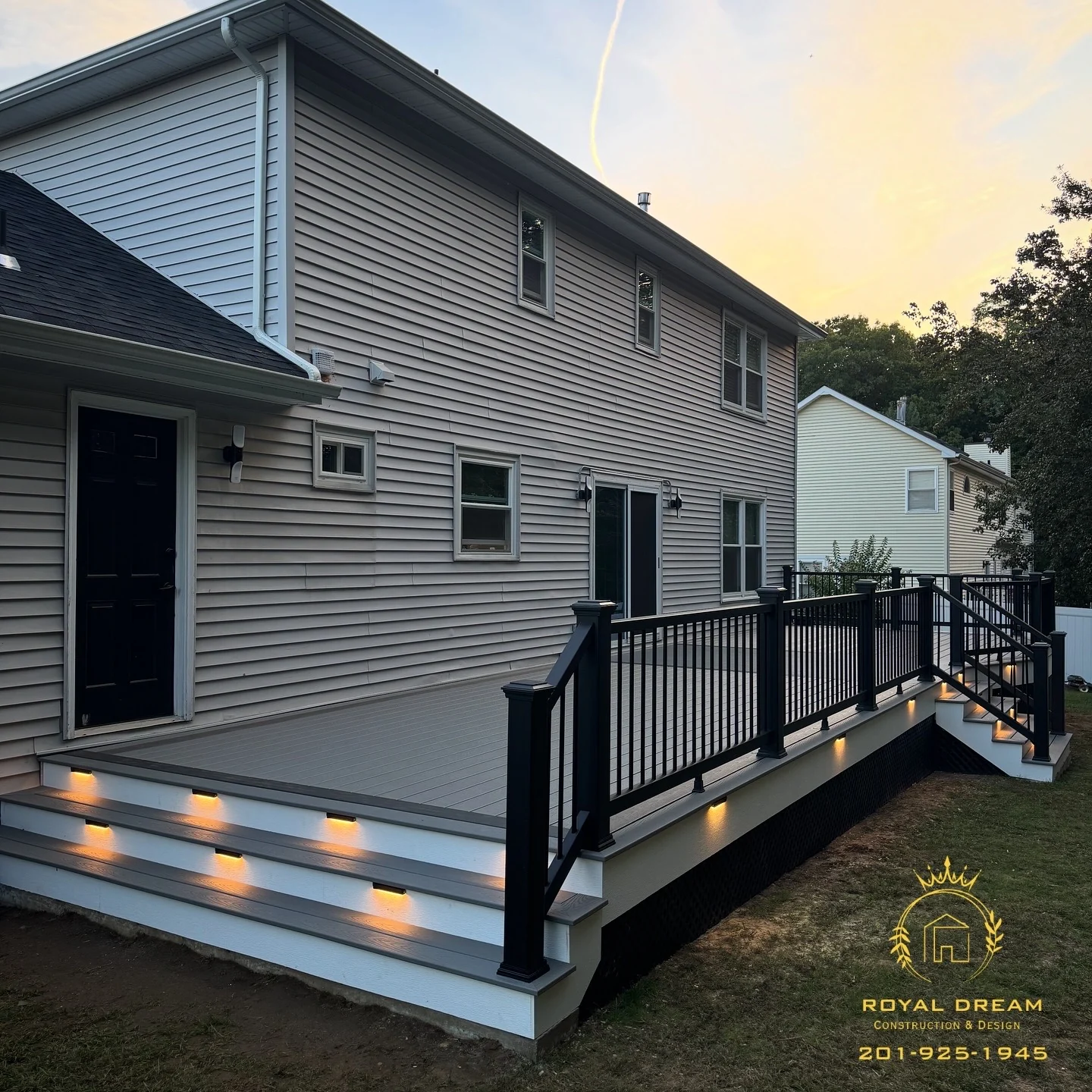 A completed Royal Dream deck with light-grey boards, black railings and illuminated steps