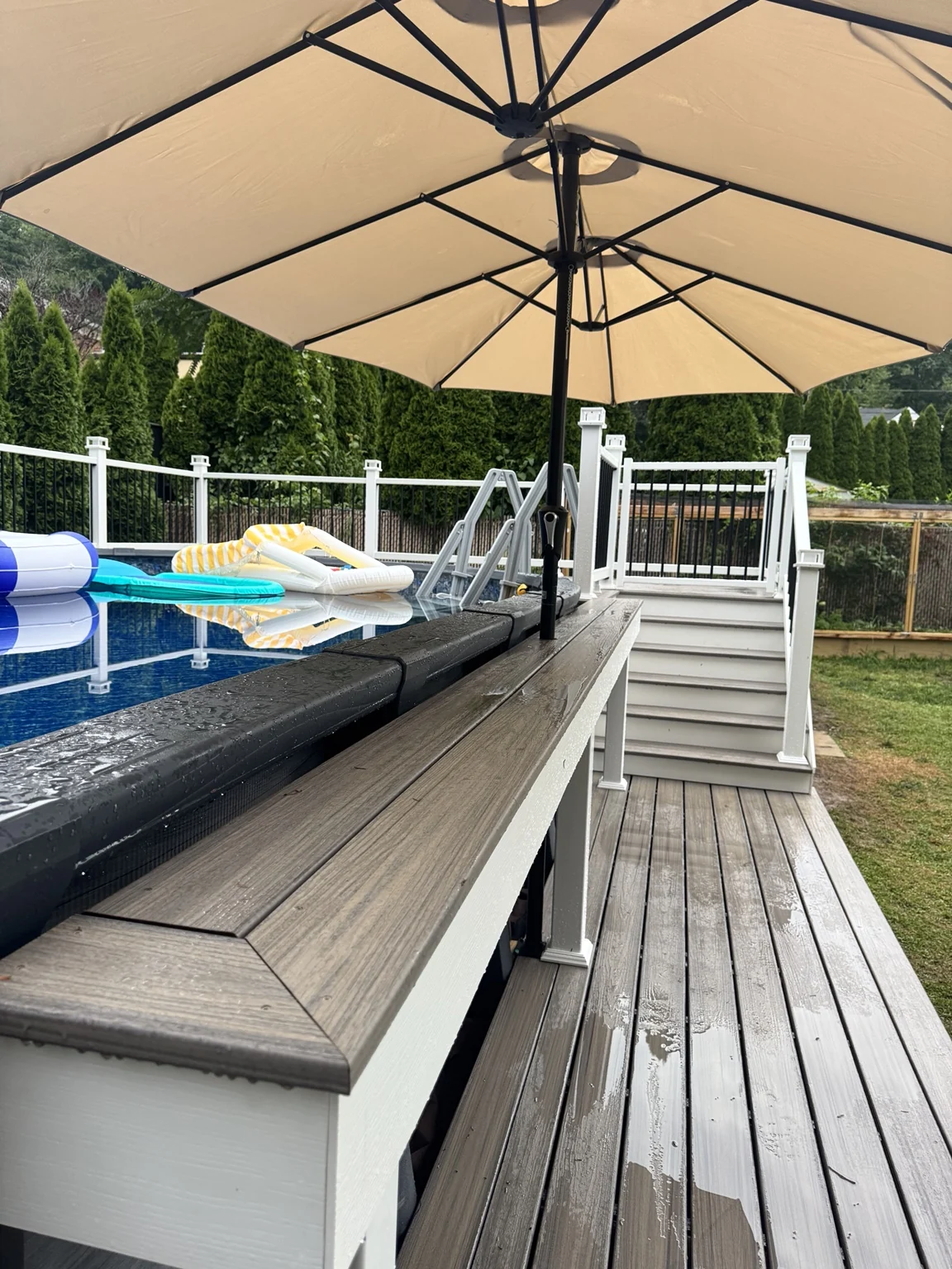 A closer view along the bar ledge, deck boards and stairs connecting the poolside levels.